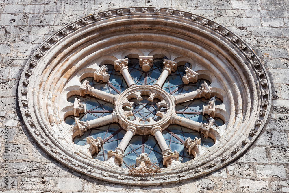 The Gothic Wheel Window also called as Rose Window or Catherine Window in the Santa Clara Church. 13th century Mendicant Gothic Architecture. Santarem, Portugal.