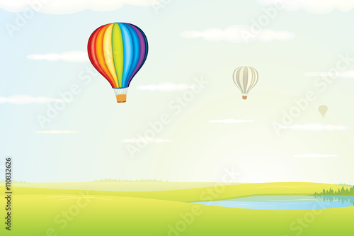 Hot Air Balloon over Green Fields. Image