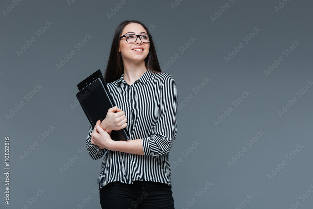Happy businesswoman in glasses holding folders Happy businesswoman in glasses holding folders