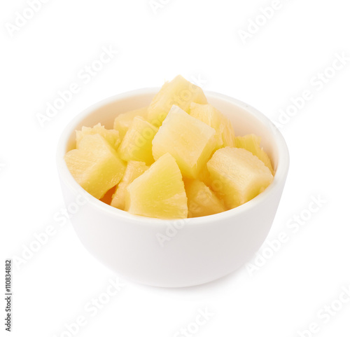 Pile of canned pineapple over isolated white background