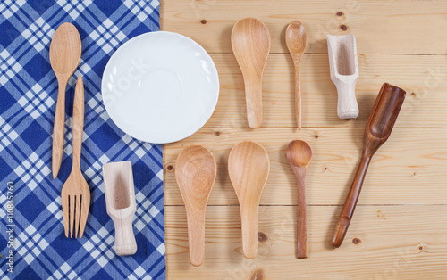 Wooden kitchen utensil on tablecloth background