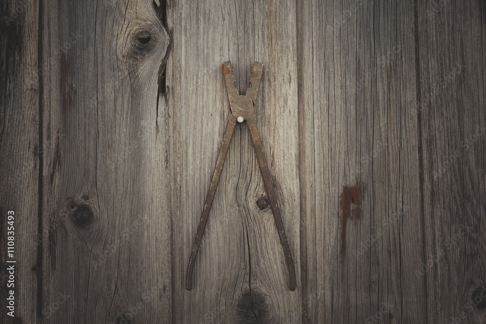 Rusty and grungy old tool on dark wood background Rusty and grungy old tool on dark wood background