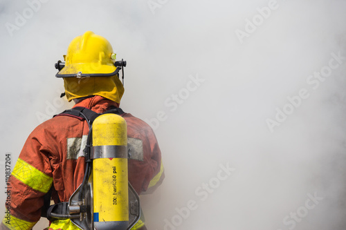 single fireman in operation surround with smoke