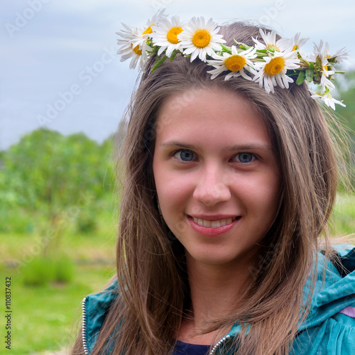  Beautiful  girl with a wreath of daisies on her head