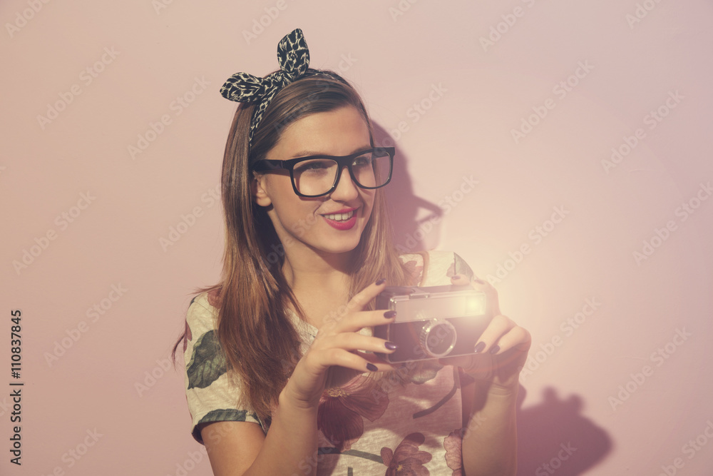 Beautiful young hipster girl with old camera.
Beautiful young hipster girl with old camera.