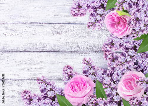 Lilac flowers with roses on shabby wooden planks