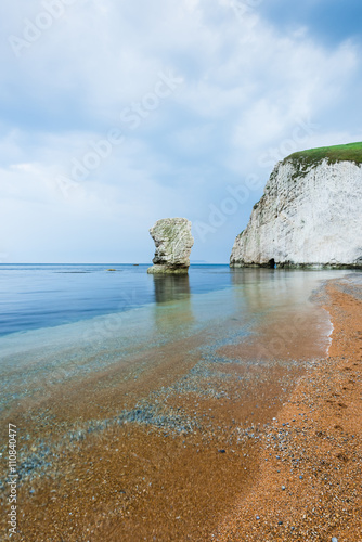 lonelly rock formation at coastline in Dorset photo