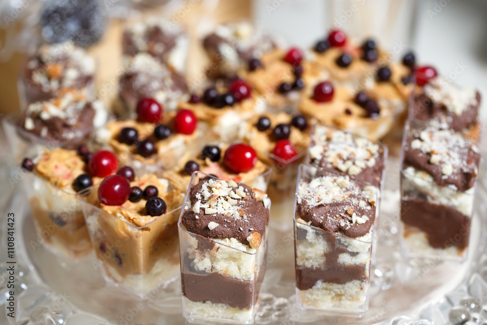 Sweet Dessert. Chocolate, nuts and berry pudding in small plasti Sweet Dessert. Chocolate, nuts and berry pudding in small plasti