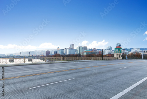 concrete road with cityscape and skyline of portland in blue sky