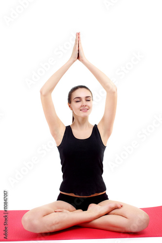 beautiful young woman yoga posing on a studio background