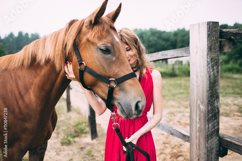 happy woman enjoys with her favorite horse