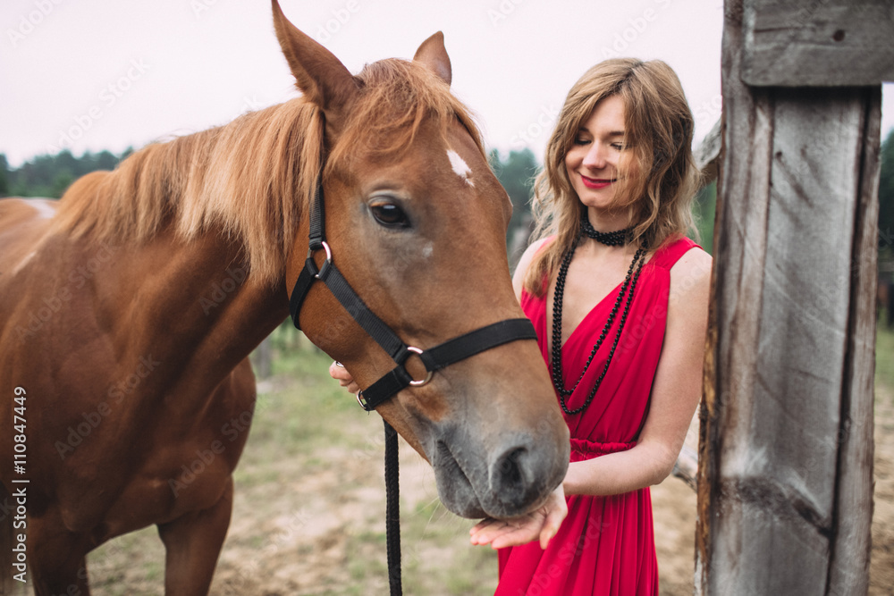 Obraz premium beautiful horse and his mistress walking on meadow