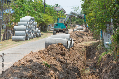 Digging drains concrete pipeline on construction site