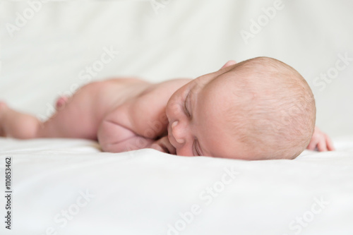 Newborn baby sleeping on a white background