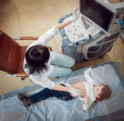 Doctor and little girl patient. Ultrasound equipment.