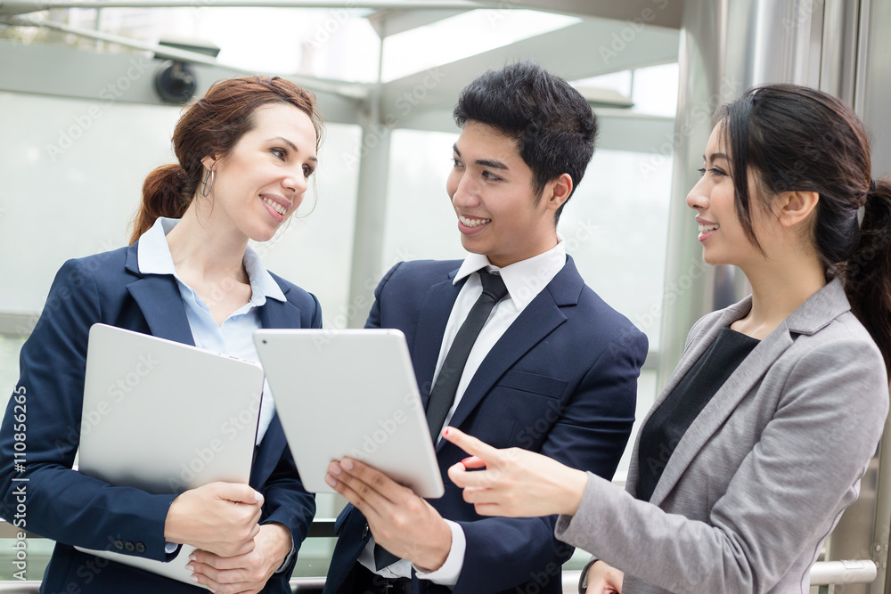 Group of business people discuss on tablet pc Group of business people discuss on tablet pc