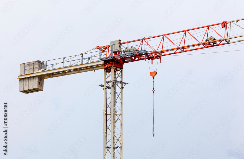 Red and white  hoisting crane
