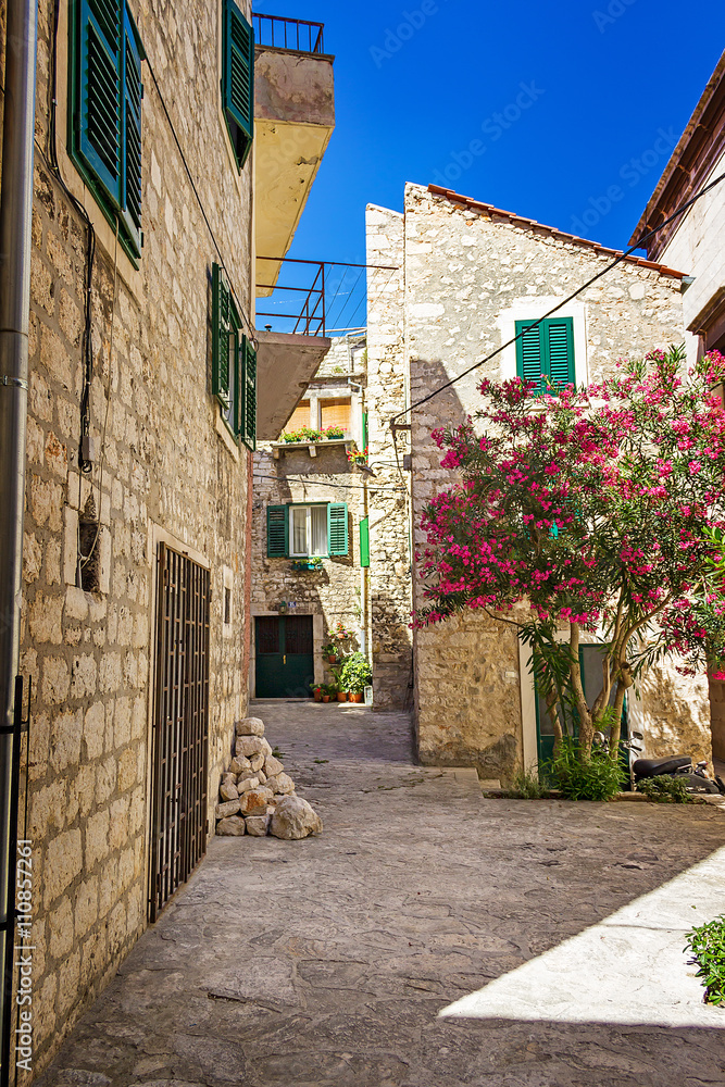 Narrow old streets and yards in Sibenik city, Croatia, medieval zone
