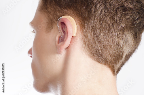 Teenager with hearing aid photo