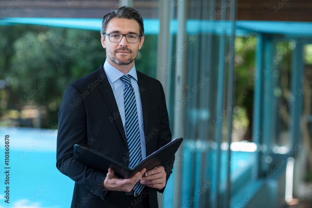 Fototapeta premium Businessman in suit holding folder