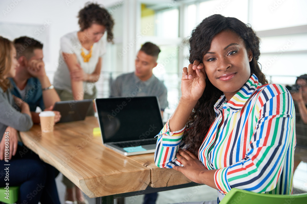 Image of a succesful casual business woman using laptop during meeting Image of a succesful casual business woman using laptop during meeting
