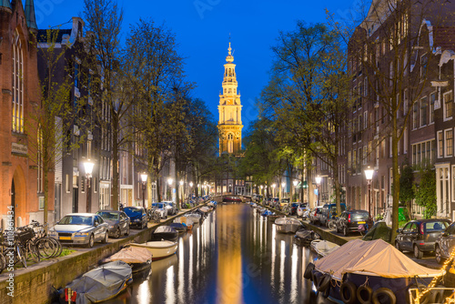 Zuiderkerk church tower at the end of a canal in the city of Ams