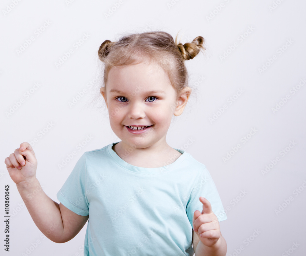little girl looking at the camera and raised the thumbs up. pretty cute blonde little girl looking at the camera and raised the thumbs up. pretty cute blonde