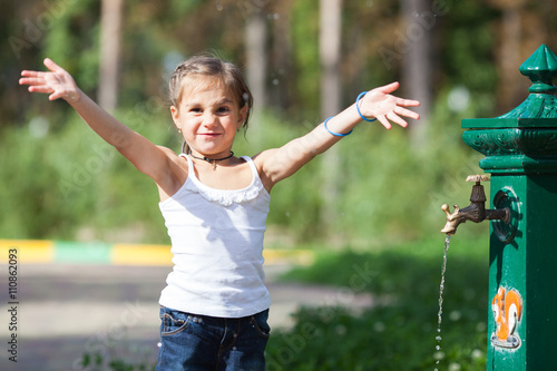 Girl splashing water at the park
