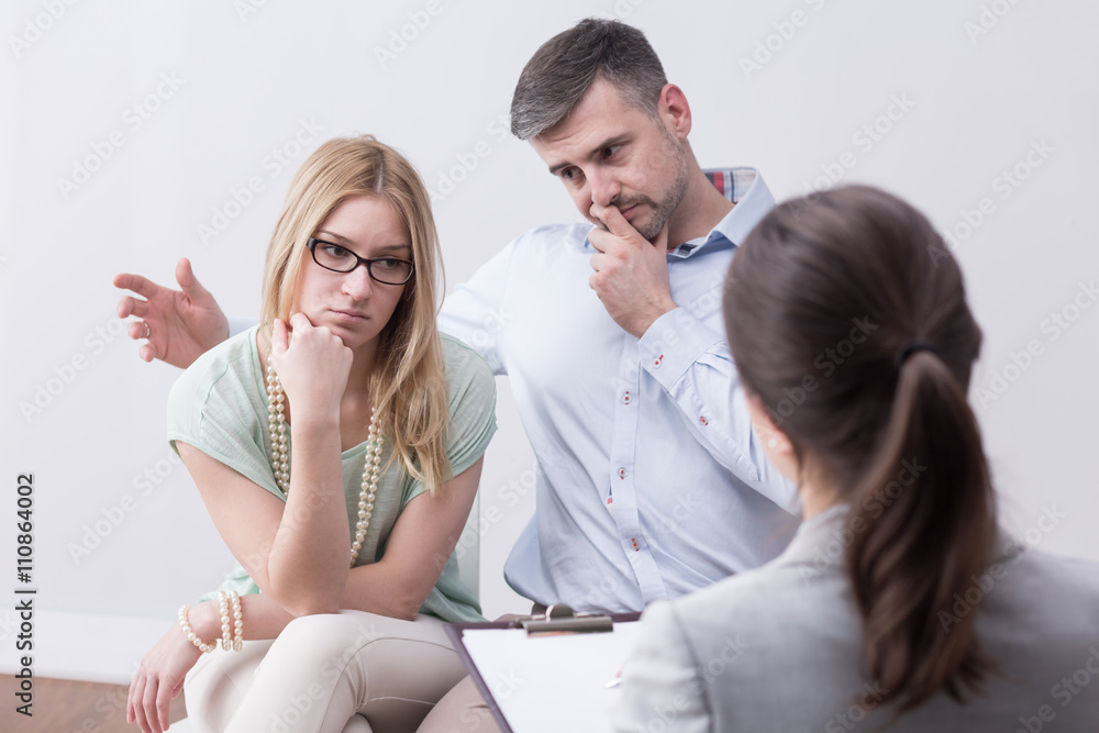 Young married unhappy couple on psychotherapy session Young married unhappy couple on psychotherapy session