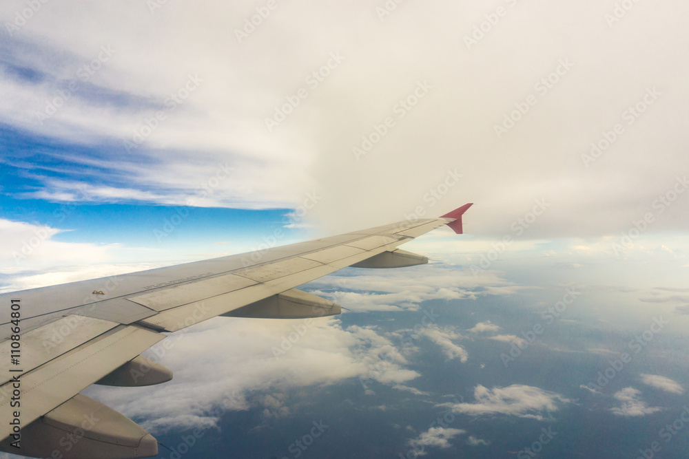 Wing of airplane over the clouds Wing of airplane over the clouds