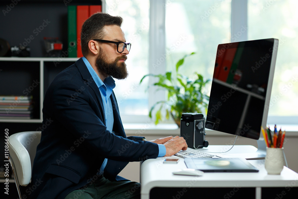 Handsome young man working from home office Handsome young man working from home office