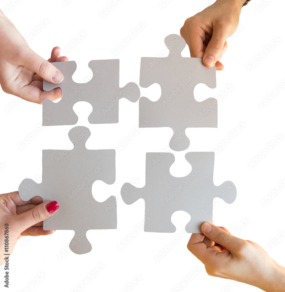 close up of hands connecting puzzle pieces close up of hands connecting puzzle pieces