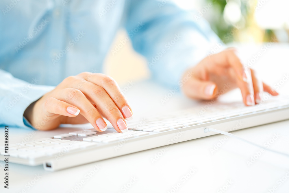 Woman office worker typing on the keyboard Woman office worker typing on the keyboard