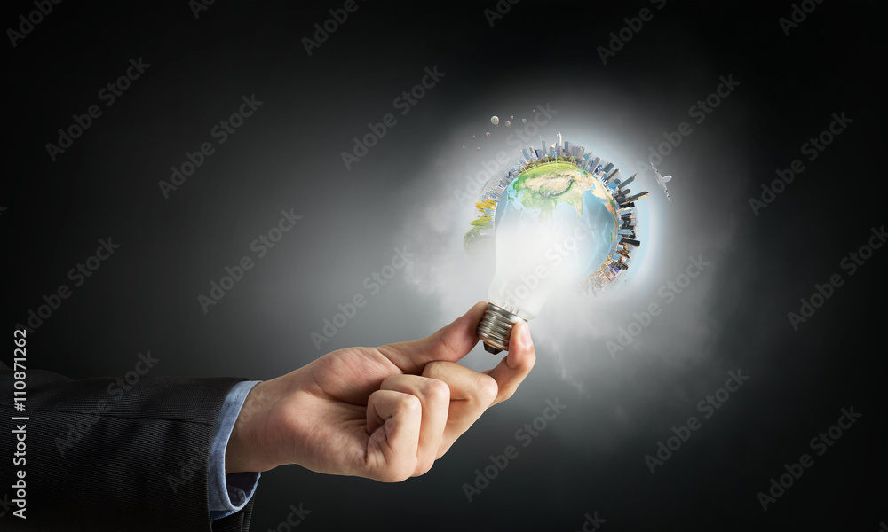 Glowing bulb in hand Glowing bulb in hand