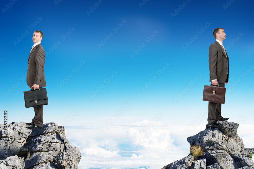 Businessmen standing on peaks 