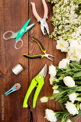 Garden tools, Tools for floristics and flowers on a wooden table. photo