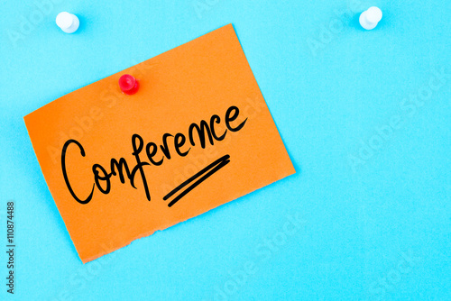 Conference written on orange paper note