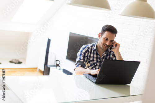Man on the phone with laptop