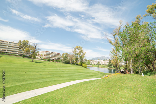 Golf course with lake and mountain in the background