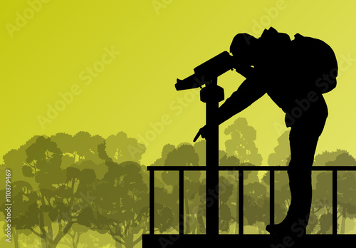 Tourist man looking through coin operated binoculars tower view