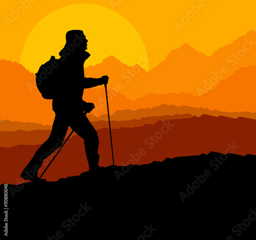 Man hiking in mountains adventure nordic walking with poles in n