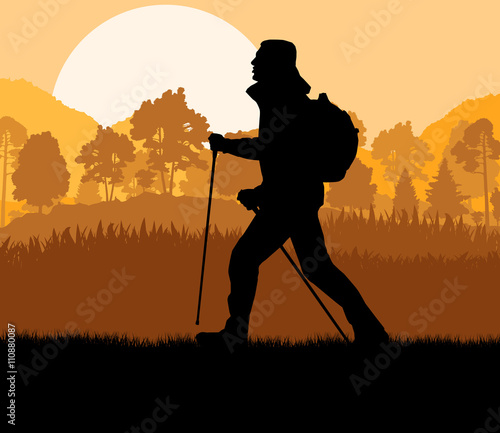 Man hiking in mountains adventure nordic walking with poles in n