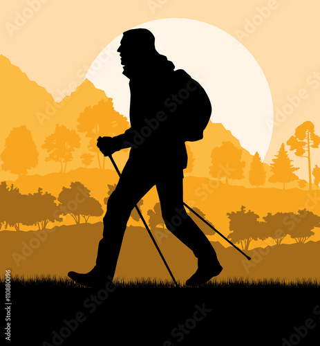 Man hiking in mountains adventure nordic walking with poles in n