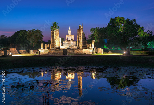 Buddha Statue at Wat Mahathat in Sukhothai Historical Park at twilight time.