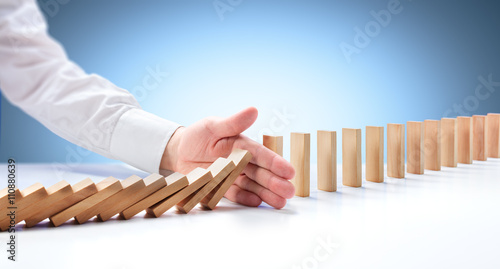 Problem Solving - Hand Stopping Domino Effect
 photo