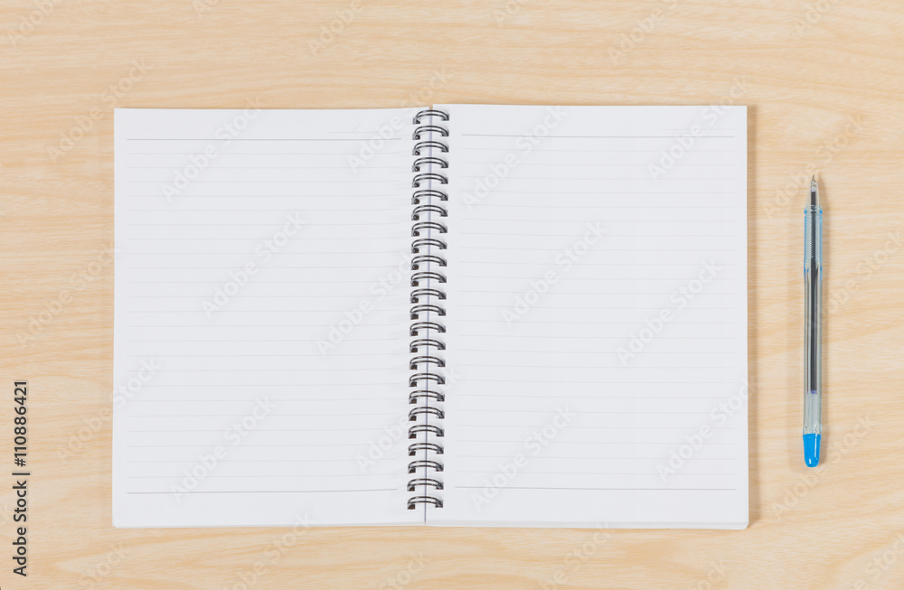 notebook and pen on wood