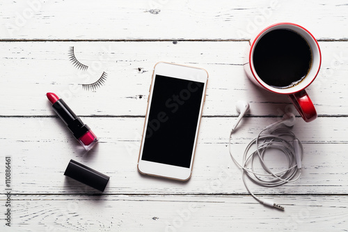 Workspace with female accessories, Overhead view of smartphone a photo