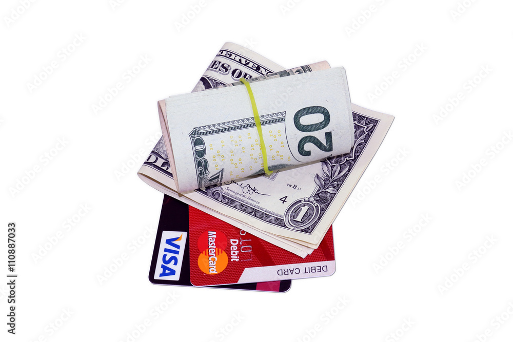 Credit debit card under bundle of twenty and one dollars isolated on white background Credit debit card under bundle of twenty and one dollars isolated on white background