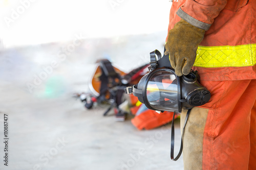 fireman hand in glove hold oxygen mask