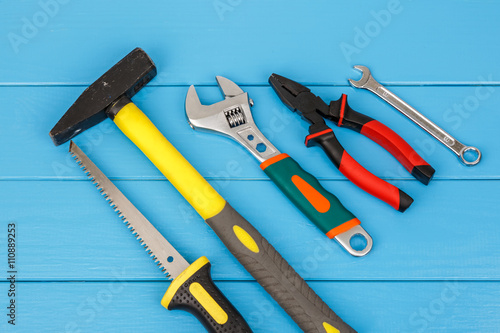 Work tools laying on blue wooden background